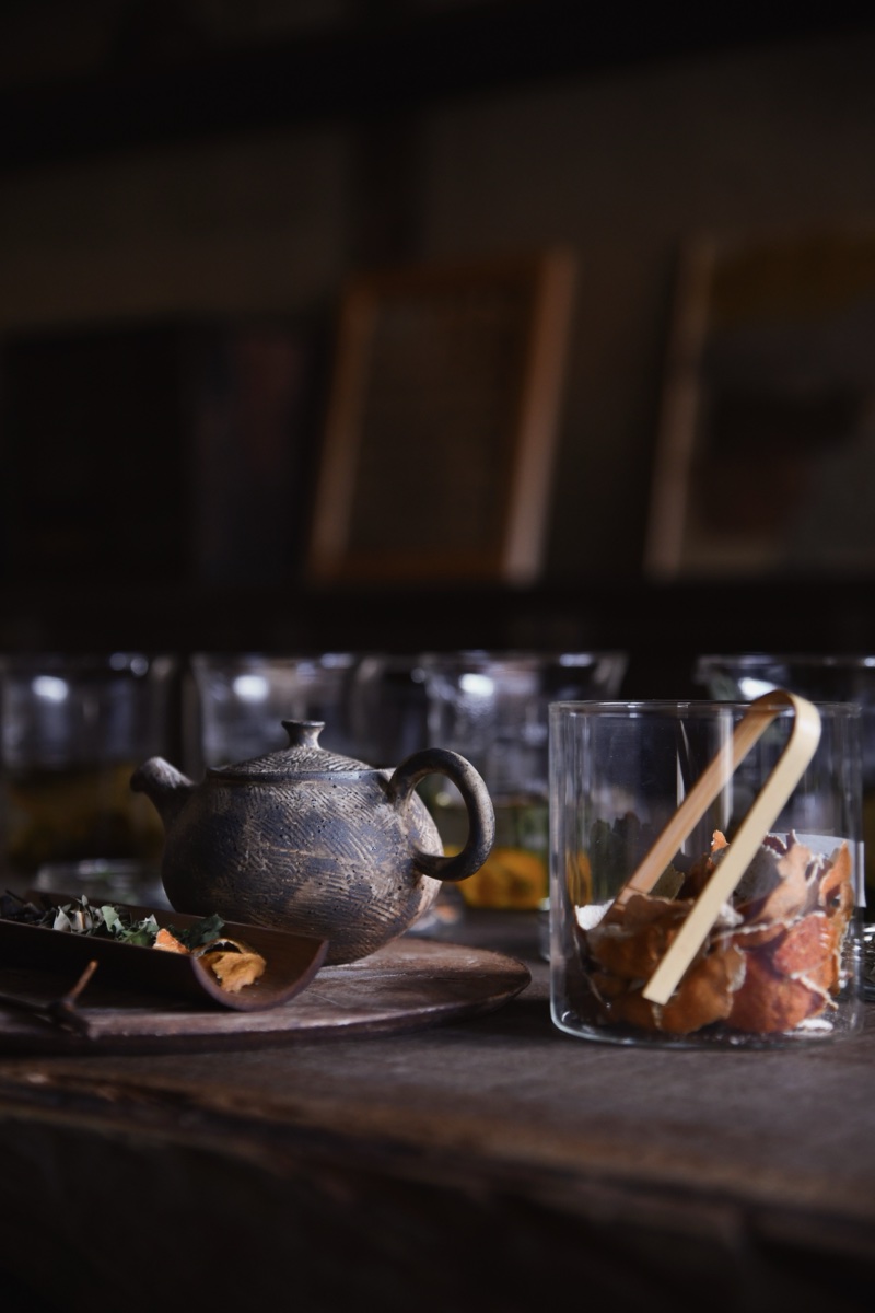 A ceramic teapot and botanical ingredients for tea blending